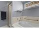 Bathroom featuring a jetted tub with marble surround, glass shower, and light gray walls at 508 Viola St, Palmer Lake, CO 80133