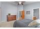 Bedroom featuring carpeted floors, ceiling fan, light gray walls and an attached bathroom at 508 Viola St, Palmer Lake, CO 80133