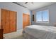 Bedroom with carpeted floors, light gray walls, ceiling fan and natural light from a large window at 508 Viola St, Palmer Lake, CO 80133