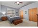 Bedroom featuring carpeted floors, ceiling fan, natural light and two spacious closet doors at 508 Viola St, Palmer Lake, CO 80133