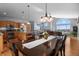 Open dining room and kitchen featuring hardwood floors, granite countertops and stainless steel appliances at 508 Viola St, Palmer Lake, CO 80133