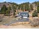 Charming home nestled in a mountain setting with a driveway, and natural landscaping offering curb appeal and serene living at 508 Viola St, Palmer Lake, CO 80133