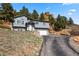 Charming two-story home with an attached garage, sits nicely on a grassy hill at 508 Viola St, Palmer Lake, CO 80133