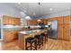 Stylish kitchen with stainless steel appliances and an island with a granite countertop at 508 Viola St, Palmer Lake, CO 80133