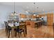 Open kitchen with modern appliances, an island with bar seating, and a dining area at 508 Viola St, Palmer Lake, CO 80133