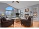 Cozy living room features large windows, a fireplace, and comfortable seating at 508 Viola St, Palmer Lake, CO 80133