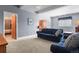 Living area featuring a sofa, chair, and convenient access to other rooms enhancing the home's functionality at 508 Viola St, Palmer Lake, CO 80133