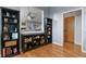 Living room featuring hardwood floors, light gray walls, built in shelves and an open entryway at 508 Viola St, Palmer Lake, CO 80133