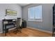 Office featuring hardwood floors, a large window, light gray walls and black furniture at 508 Viola St, Palmer Lake, CO 80133