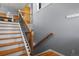 View of wooden staircase with white risers leading to the upper level of the home with a gray accent wall at 508 Viola St, Palmer Lake, CO 80133