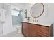 Bathroom showcasing tiled shower/tub, modern vanity with wood cabinets, and neutral walls at 2675 S Eudora St, Denver, CO 80222