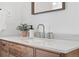 Close up of bathroom vanity with wood cabinets, white countertop, and modern fixtures at 2675 S Eudora St, Denver, CO 80222