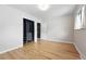 Empty room with hardwood floors, closet, and built-in storage, creating a bright and airy space at 2675 S Eudora St, Denver, CO 80222