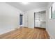 Empty room with hardwood floors, closet, and white walls, creating a bright and airy space at 2675 S Eudora St, Denver, CO 80222