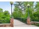 Scenic bridge with vintage-style lamps and lush trees offering a tranquil atmosphere at 2675 S Eudora St, Denver, CO 80222