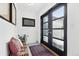 Bright entryway with a stylish bench, decorative artwork, and a contemporary glass front door at 2675 S Eudora St, Denver, CO 80222