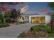 Charming single-story home with a modern garage door and well-maintained front yard at dusk at 2675 S Eudora St, Denver, CO 80222