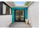 Inviting front entry featuring black double doors, colorful accent wall, and modern lighting at 2675 S Eudora St, Denver, CO 80222