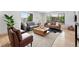 Large living room featuring hardwood floors, modern furnishings, and plenty of natural light from large windows at 2675 S Eudora St, Denver, CO 80222