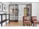 Sitting area showcasing an decorative metal gate, hardwood floors, and cozy seating creating an inviting atmosphere at 2675 S Eudora St, Denver, CO 80222