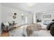 Bright main bedroom features white walls, wood floors, and French doors leading to the outdoor space at 2675 S Eudora St, Denver, CO 80222