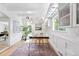 Well-lit office space featuring stylish desk, hardwood floors, unique lighting, and views to the backyard at 2675 S Eudora St, Denver, CO 80222