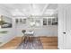 Bright office with white walls, built in shelves and cabinets and hardwood flooring with geometrically designed lighting at 2675 S Eudora St, Denver, CO 80222