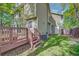 View of the backyard showing the deck and stairs leading to the grassy area and fence at 3966 Bosque Ct, Boulder, CO 80301