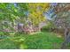 Lush backyard with mature trees, a well-maintained lawn, and a spacious deck for outdoor enjoyment at 3966 Bosque Ct, Boulder, CO 80301