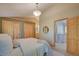 Bright bedroom with natural wood doors and a round mirror at 3966 Bosque Ct, Boulder, CO 80301