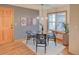 Well lit dining area with modern lighting, and natural wood accents by a large window at 3966 Bosque Ct, Boulder, CO 80301