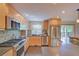 Bright kitchen featuring stainless steel appliances, light wood cabinets, and stylish mosaic backsplash at 3966 Bosque Ct, Boulder, CO 80301