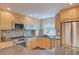 Bright kitchen featuring stainless steel appliances, light wood cabinets, and stylish mosaic backsplash at 3966 Bosque Ct, Boulder, CO 80301