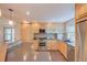 Bright kitchen featuring stainless steel appliances, light wood cabinets, and stylish mosaic backsplash at 3966 Bosque Ct, Boulder, CO 80301