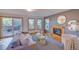 Cozy living room featuring a fireplace, hardwood floors, large windows, and sliding glass doors to the deck at 3966 Bosque Ct, Boulder, CO 80301