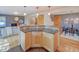 Open floor plan showing living room with fireplace and dining area with stylish kitchen island at 3966 Bosque Ct, Boulder, CO 80301