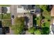 Aerial view of a home with a well-kept yard, mature trees, and a driveway at 6470 Field St, Arvada, CO 80004