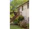 Home exterior with deck and stairs leading to a green yard; lush vegetation surrounds the home at 6470 Field St, Arvada, CO 80004