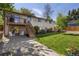 Well-maintained backyard with lush lawn, patio, and wooden deck featuring stairs to the yard at 6470 Field St, Arvada, CO 80004