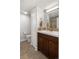 Bathroom with modern vanity, mosaic backsplash, and tile flooring; toilet is out of the way at 6470 Field St, Arvada, CO 80004