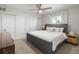 Calm bedroom features a gray upholstered bed frame, ceiling fan, and large closet at 6470 Field St, Arvada, CO 80004