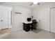 A bright bedroom with a ceiling fan, carpeted floors, closet and desk at 6470 Field St, Arvada, CO 80004