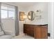 Serene Bedroom featuring a gray armchair, natural light, wood dresser, and crib at 6470 Field St, Arvada, CO 80004