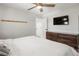 Relaxing bedroom with ceiling fan, natural-toned dresser, and large closet at 6470 Field St, Arvada, CO 80004