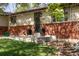 Charming home featuring a brick facade, a well-manicured lawn, and elegant planter boxes at 6470 Field St, Arvada, CO 80004