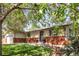 Charming ranch style home featuring a well manicured lawn, brick accents, and mature shade tree at 6470 Field St, Arvada, CO 80004