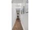 Bright hallway features hardwood floors, skylights, and gallery walls with artwork at 6470 Field St, Arvada, CO 80004