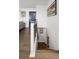 Hallway featuring hardwood floors, modern railings and a blue door at 6470 Field St, Arvada, CO 80004