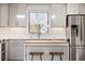 Updated kitchen with island, stainless steel appliances and window over sink at 6470 Field St, Arvada, CO 80004