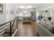 Open concept kitchen, dining and living space with wood floors and stainless steel appliances at 6470 Field St, Arvada, CO 80004